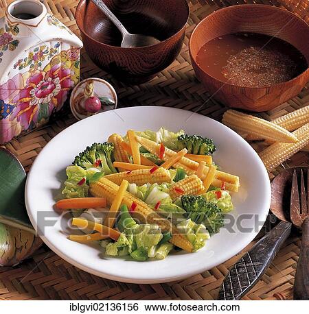 Stock Photograph - Thai pan-fried vegetables, spring onions, garlic, chilli, carrot, broccoli, corn, Chinese cabbage, rice wine and fish sauce and vegetables, tossed in a wok, Thailand, Asia. Fotosearch