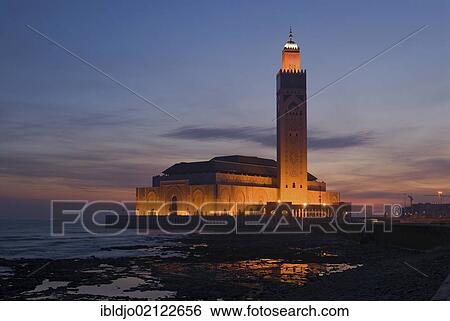The floodlit Hassan II Mosque at the coast of the Atlantic Ocean at the blue hour in the morning, Casablanca, Morocco, Africa View Large Photo Image Stock Photograph - The floodlit Hassan II Mosque at the coast of the Atlantic Ocean at the blue hour in the morning, Casablanca, Morocco, Africa. Fotosearch