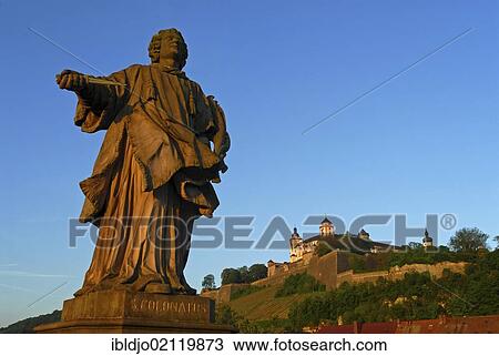 The statue of Saint Colman on the Alte Mainbruecke, Old Main Bridge with the Festung Marienberg, Marienberg Fortress at back, Wuerzburg, Lower Franconia, Bavaria, Germany, Europe View Large Photo Image Stock Image - The statue of Saint Colman on the Alte Mainbruecke, Old Main Bridge with the Festung Marienberg, Marienberg Fortress at back, Wuerzburg, Lower Franconia, Bavaria, Germany, Europe. Fotosearch