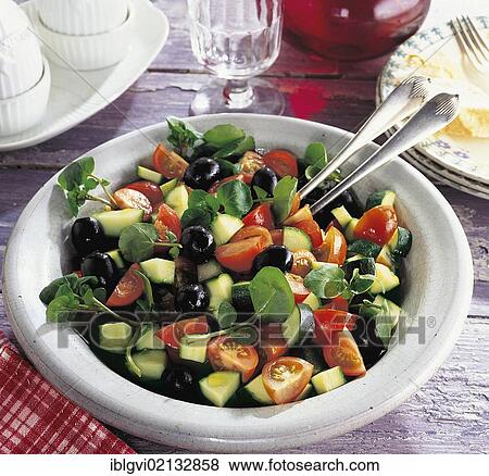 Stock Photo - Tomato salad, garden style, cocktail tomatoes, olives, cress and zucchini with vinaigrette, France, Europe. Fotosearch
