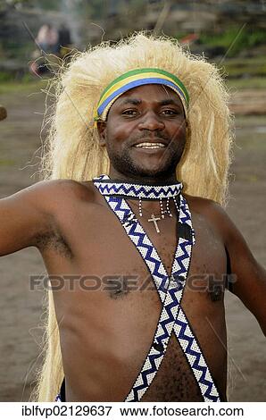 Traditional dancer during a folklore event in a village of former hunters near the village of Kinigi on the edge of the Volcanoes National Park, Parc National des Volcans, Rwanda, Africa View Large Photo Image Stock Photo - Traditional dancer during a folklore event in a village of former hunters near the village of Kinigi on the edge of the Volcanoes National Park, Parc National des Volcans, Rwanda, Africa. Fotosearch