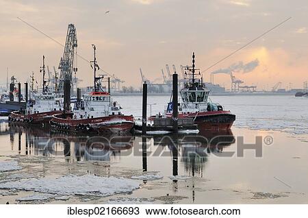 Tug boats on the Elbe river, port of Hamburg in winter, Neumuehlen, Hamburg, Germany, Europe View Large Photo Image Stock Image - Tug boats on the Elbe river, port of Hamburg in winter, Neumuehlen, Hamburg, Germany, Europe. Fotosearch