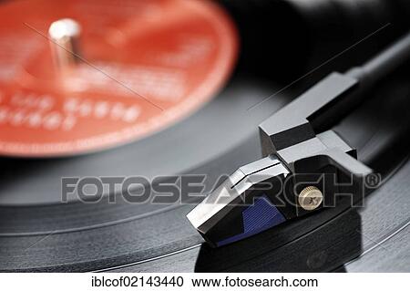 Stock Image - Turntable playing an LP record. Fotosearch