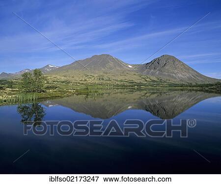 Twin peaks of the Stygghøin, Stygghoin mountain range are reflected in the Dørålstjørnin, Doralstjornin Lake, Rondane National Park, Norway, Scandinavia, Europe View Large Photo Image Stock Photo - Twin peaks of the Stygghøin, Stygghoin mountain range are reflected in the Dørålstjørnin, Doralstjornin Lake, Rondane National Park, Norway, Scandinavia, Europe. Fotosearch