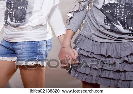 Two young teenage girls holding hands, detail View Large Photo Image Stock Image - Two young teenage girls holding hands, detail. Fotosearch