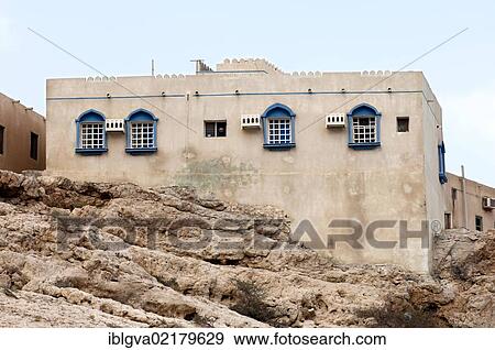Typical residential house with four arched windows on a rock near Ash Shab, Sultanate of Oman, Middle East, Southwest Asia, Asia View Large Photo Image Stock Photo - Typical residential house with four arched windows on a rock near Ash Shab, Sultanate of Oman, Middle East, Southwest Asia, Asia. Fotosearch
