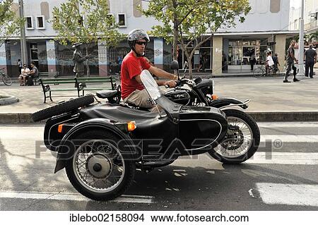 Picture - URAL motorcycle from Russia, motorcycle with a sidecar, Cienfuegos, Cuba, Greater Antilles, Caribbean, Central America, America, North America. Fotosearch
