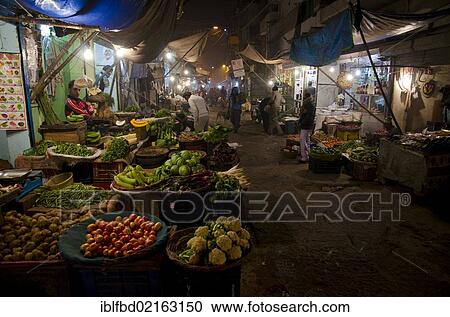 Stock Image - Vegetable stall on the nightmarket in the suburb of Paharganj, New Delhi, India, Asia. Fotosearch