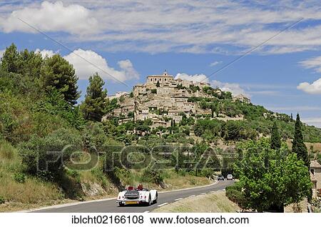 Stock Photo - Vintage car on the road towards Gordes, Vaucluse, Provence-Alpes-Cote d'Azur, Southern France, France, Europe, PublicGround, Europe. Fotosearch