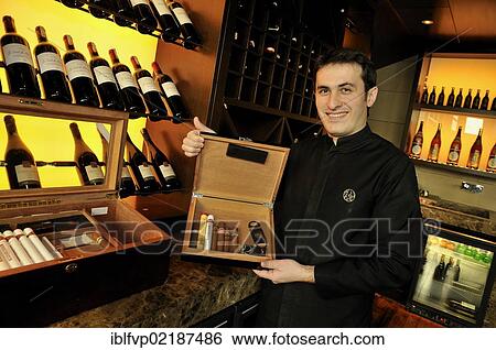 Stock Photograph - Waiter holding a box of cigars in the restaurant Chinar, Baku, Azerbaijan, Caucasus, Middle East, Asia. Fotosearch