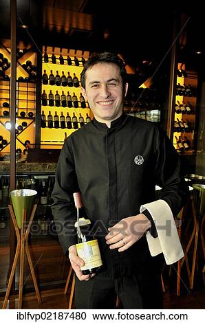Stock Image - Waiter with a bottle of wine in the restaurant Chinar, Baku, Azerbaijan, Caucasus, Middle East, Asia. Fotosearch