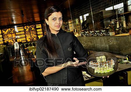 Stock Image - Waitress holding sushi in the restaurant Chinar, Baku, Azerbaijan, Caucasus, Middle East, Asia. Fotosearch