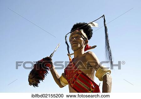 Warrior of the Konyak tribe waiting to perform ritual dances at the Hornbill Festival, Kohima, Nagaland, India, Asia View Large Photo Image Stock Image - Warrior of the Konyak tribe waiting to perform ritual dances at the Hornbill Festival, Kohima, Nagaland, India, Asia. Fotosearch