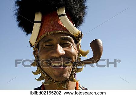 Warrior of the Konyak tribe waiting to perform ritual dances at the Hornbill Festival, Kohima, Nagaland, India, Asia View Large Photo Image Stock Image - Warrior of the Konyak tribe waiting to perform ritual dances at the Hornbill Festival, Kohima, Nagaland, India, Asia. Fotosearch