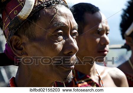 Warrior of the Konyak tribe waiting to perform ritual dances at the Hornbill Festival, Kohima, Nagaland, India, Asia View Large Photo Image Stock Image - Warrior of the Konyak tribe waiting to perform ritual dances at the Hornbill Festival, Kohima, Nagaland, India, Asia. Fotosearch