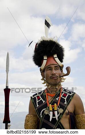 Warrior of the Konyak tribe waiting to perform ritual dances at the Hornbill Festival, Kohima, Nagaland, India, Asia View Large Photo Image Stock Photo - Warrior of the Konyak tribe waiting to perform ritual dances at the Hornbill Festival, Kohima, Nagaland, India, Asia. Fotosearch