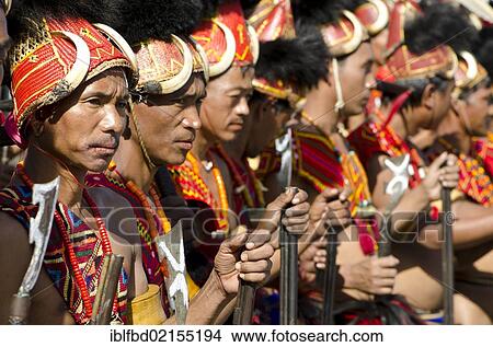 Warriors of the Konyak tribe waiting to perform ritual dances at the Hornbill Festival, Kohima, Nagaland, India, Asia View Large Photo Image Picture - Warriors of the Konyak tribe waiting to perform ritual dances at the Hornbill Festival, Kohima, Nagaland, India, Asia. Fotosearch