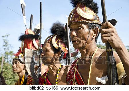 Stock Photograph - Warriors of the Phom tribe waiting to perform ritual dances at the Hornbill Festival, Kohima, Nagaland, India, Asia. Fotosearch