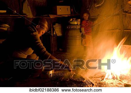 Woman and child of the San, Bushmen, cooking over an open fire in their dwelling, near Andriesvale, Kalahari, Kalahari Desert, Northern Cape, South Africa, Africa View Large Photo Image Stock Photograph - Woman and child of the San, Bushmen, cooking over an open fire in their dwelling, near Andriesvale, Kalahari, Kalahari Desert, Northern Cape, South Africa, Africa. Fotosearch