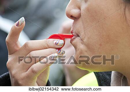 Stock Image - Woman blowing a whistle, Ver. di Bavaria - E. ON rally and demonstration, Munich, Bavaria, Germany, Europe. Fotosearch