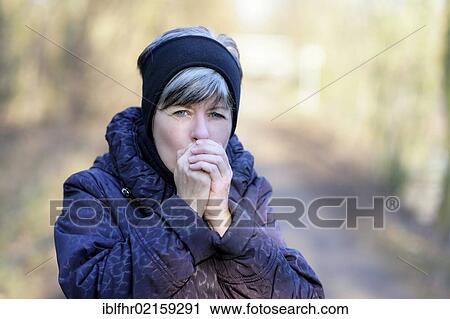 Woman breathing on her hands, warming hands View Large Photo Image Stock Image - Woman breathing on her hands, warming hands. Fotosearch