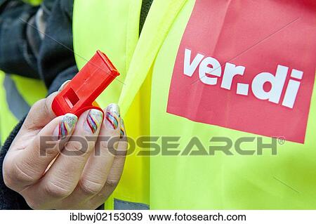 Stock Photo - Woman holding a whistle wearing a Ver. di vest, Ver. di Bavaria - E. ON rally and demonstration, Munich, Bavaria, Germany, Europe. Fotosearch