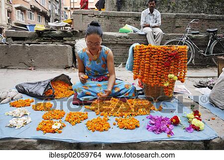Picture - Woman making and selling flower necklaces, Kathmandu, Nepal, Asia. Fotosearch