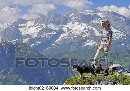 Woman with a Miniature Schnauzer, black and silver, on the summit of Jenner Mountain, Berchtesgaden National Park, Berchtesgadener Land, Bavaria, Germany, Europe, PublicGround, Europe View Large Photo Image Picture - Woman with a Miniature Schnauzer, black and silver, on the summit of Jenner Mountain, Berchtesgaden National Park, Berchtesgadener Land, Bavaria, Germany, Europe, PublicGround, Europe. Fotosearch
