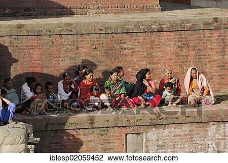 Women and children sitting on steps of the Nyatapola Pagoda, Taumadhi square, Bhaktapur, Kathmandu Valley, Nepal, Asia View Large Photo Image Stock Image - Women and children sitting on steps of the Nyatapola Pagoda, Taumadhi square, Bhaktapur, Kathmandu Valley, Nepal, Asia. Fotosearch