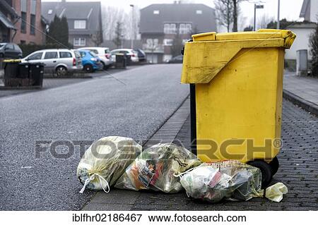 Yellow recycling bin and yellow recycling bags on a street, waste disposal, Grevenbroich, North Rhine-Westphalia, Germany, Europe View Large Photo Image Stock Photo - Yellow recycling bin and yellow recycling bags on a street, waste disposal, Grevenbroich, North Rhine-Westphalia, Germany, Europe. Fotosearch