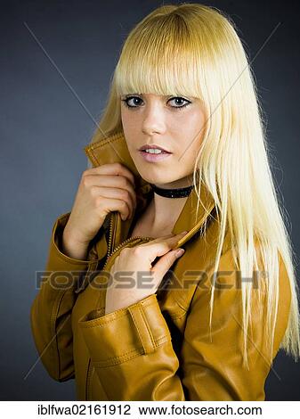 Young blond woman wearing a leather jacket View Large Photo Image Stock Image - Young blond woman wearing a leather jacket. Fotosearch