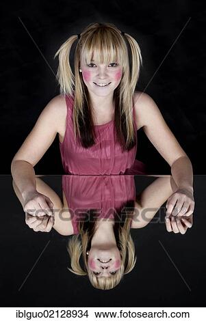Young blond woman with red painted cheeks, smiling, with a mirrored image View Large Photo Image Picture - Young blond woman with red painted cheeks, smiling, with a mirrored image. Fotosearch