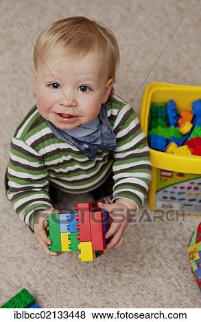 Young boy, 14 months, playing with colourful plastic Lego Duplo bricks, Germany, Europe View Large Photo Image Stock Photo - Young boy, 14 months, playing with colourful plastic Lego Duplo bricks, Germany, Europe. Fotosearch
