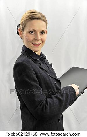 Stock Photo - Young businesswoman, manager, before going into a meeting. Fotosearch