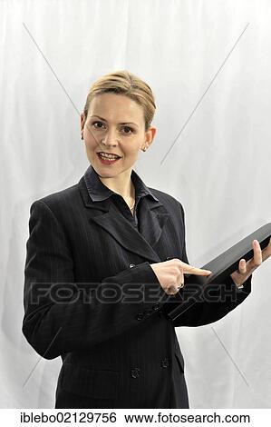 Stock Photograph - Young businesswoman, manager, before going into a meeting. Fotosearch