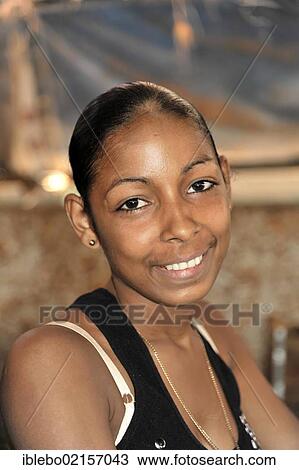 Stock Image - Young Cuban woman, salesperson at the weekly market, portrait, centre of Havana, Centro Habana, Cuba, Greater Antilles, Caribbean, Central America, America, North America. Fotosearch