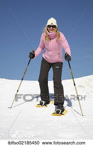 Young woman, about 25 years, snow shoe walking with sticks, against a blue sky, Thuringian Forest mountains, Thuringia, Germany, Europe View Large Photo Image Stock Image - Young woman, about 25 years, snow shoe walking with sticks, against a blue sky, Thuringian Forest mountains, Thuringia, Germany, Europe. Fotosearch