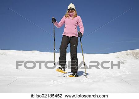 Young woman, about 25 years, snow shoe walking with sticks, against a blue sky, Thuringian Forest mountains, Thuringia, Germany, Europe View Large Photo Image Stock Image - Young woman, about 25 years, snow shoe walking with sticks, against a blue sky, Thuringian Forest mountains, Thuringia, Germany, Europe. Fotosearch
