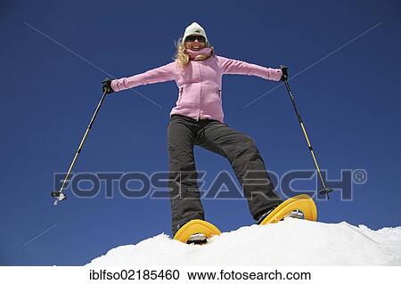 Young woman, about 25 years, snow shoe walking with sticks, against a blue sky, Thuringian Forest mountains, Thuringia, Germany, Europe View Large Photo Image Stock Image - Young woman, about 25 years, snow shoe walking with sticks, against a blue sky, Thuringian Forest mountains, Thuringia, Germany, Europe. Fotosearch