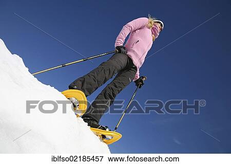 Young woman, about 25 years, snow shoe walking with sticks, against a blue sky, Thuringian Forest mountains, Thuringia, Germany, Europe View Large Photo Image Stock Photo - Young woman, about 25 years, snow shoe walking with sticks, against a blue sky, Thuringian Forest mountains, Thuringia, Germany, Europe. Fotosearch