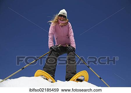 Young woman, about 25 years, snow shoe walking with sticks, against a blue sky, Thuringian Forest mountains, Thuringia, Germany, Europe View Large Photo Image Stock Photo - Young woman, about 25 years, snow shoe walking with sticks, against a blue sky, Thuringian Forest mountains, Thuringia, Germany, Europe. Fotosearch