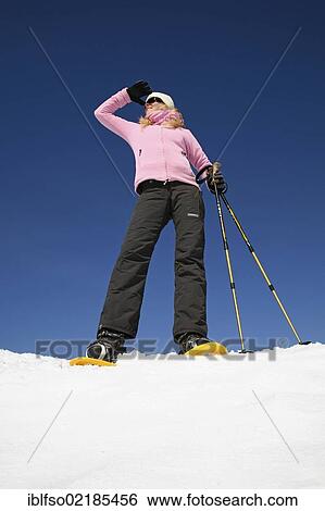 Young woman, about 25 years, snow shoe walking with sticks, against a blue sky, Thuringian Forest mountains, Thuringia, Germany, Europe View Large Photo Image Stock Photograph - Young woman, about 25 years, snow shoe walking with sticks, against a blue sky, Thuringian Forest mountains, Thuringia, Germany, Europe. Fotosearch