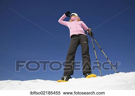 Young woman, about 25 years, snow shoe walking with sticks, against a blue sky, Thuringian Forest mountains, Thuringia, Germany, Europe View Large Photo Image Stock Photography - Young woman, about 25 years, snow shoe walking with sticks, against a blue sky, Thuringian Forest mountains, Thuringia, Germany, Europe. Fotosearch