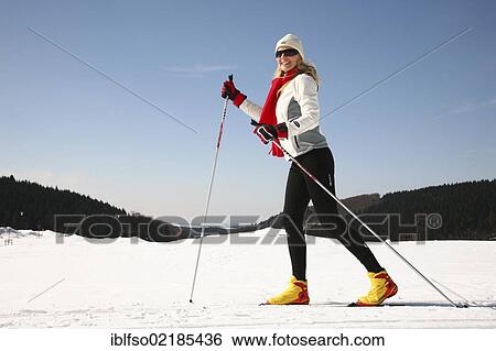 Stock Photograph - Young woman, about 25 years, cross-country skiing, near Masserberg, Thuringian Forest mountains, Thuringia, Germany, Europe. Fotosearch