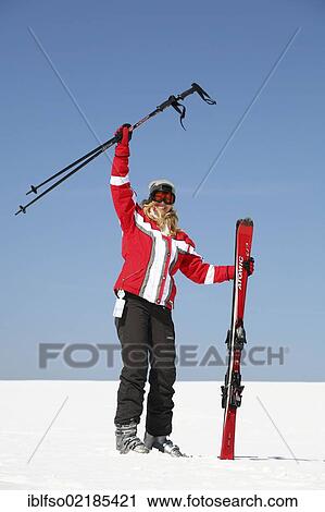 Young woman, about 25 years, waving with her ski sticks, against a blue sky, Thuringian Forest mountains, Thuringia, Germany, Europe View Large Photo Image Stock Image - Young woman, about 25 years, waving with her ski sticks, against a blue sky, Thuringian Forest mountains, Thuringia, Germany, Europe. Fotosearch