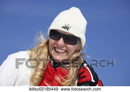 Young woman, about 25 years, wearing a cap, dark sunglasses and a red scarf, against a blue sky, holding a ski stick, smiling, Thuringian Forest mountains, Thuringia, Germany, Europe View Large Photo Image Stock Photo - Young woman, about 25 years, wearing a cap, dark sunglasses and a red scarf, against a blue sky, holding a ski stick, smiling, Thuringian Forest mountains, Thuringia, Germany, Europe. Fotosearch