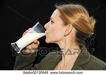 Young woman drinking milk View Large Photo Image Stock Photo - Young woman drinking milk. Fotosearch