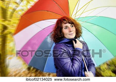 Stock Photography - Young woman holding an umbrella. Fotosearch