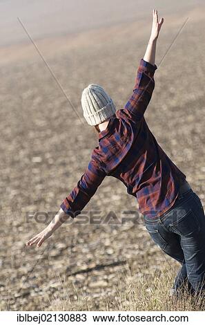 Young woman in a field, balance View Large Photo Image Stock Image - Young woman in a field, balance. Fotosearch