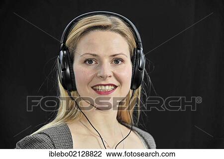 Young woman listening to music with headphones View Large Photo Image Stock Image - Young woman listening to music with headphones. Fotosearch